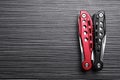 Modern compact portable multitool on black wooden table, top view. Space for text Royalty Free Stock Photo