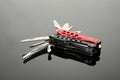 Modern compact portable multitool on grey table Royalty Free Stock Photo