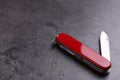 Modern compact portable multitool on grey table. Space for text Royalty Free Stock Photo