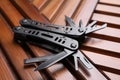 Modern compact portable multitool on wooden table, closeup Royalty Free Stock Photo