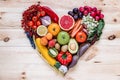 Modern composition of fresh healthy vegetables and fruits on the wooden table in the kitchen. Vegetarian vegan background. Royalty Free Stock Photo