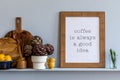 Modern composition on the kitchen interior with mock up photo frame, wooden cutting board, herbs, vegetables.