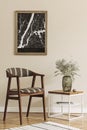 Modern composition of living room interior with brown mock up poster frame, design retro chair, coffee table, vase with flower. Royalty Free Stock Photo