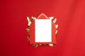 Creative composition with red envelope and blank postcard template with gold leaves on a red background Royalty Free Stock Photo