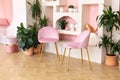 Modern composition of wabi sabi interior with arch shelf with home decoration and pink chairs.