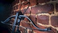 A modern compound crossbow handgun on the red brick wall background. Old weapon concept