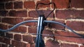 A modern compound crossbow handgun on the red brick wall background. Old weapon concept