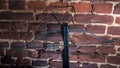 A modern compound crossbow handgun on the red brick wall background. Old weapon concept