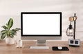 Modern computer with blank monitor screen and peripherals on wooden table indoors