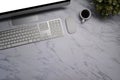 Computer, coffee cup, wireless keyboard and mouse on marble background. Royalty Free Stock Photo