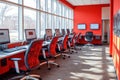 Modern computer lab bright red walls red chairs sunlight streaming through windows Royalty Free Stock Photo
