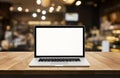 Modern computer,laptop with blank screen on table with blur cafe Royalty Free Stock Photo