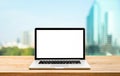 Modern computer,laptop with blank screen on wood table with office window view background Royalty Free Stock Photo