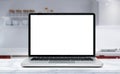 Modern computer,laptop with blank screen on Wood table top on blurred kitchen background Royalty Free Stock Photo