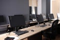 Modern computers with headsets on wooden desk in office. Hotline service Royalty Free Stock Photo