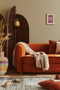 Modern concept of domestic interior with design sofa, wooden room screen, pillow, blanket, picture frame , carpet decor.