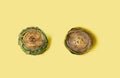 Modern concept of two organic artichokes cleaned up and trimmed, one raw fresh and second one cooked. Flat lay composition. Royalty Free Stock Photo