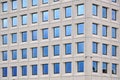 Modern concrete building with blue sky windows Royalty Free Stock Photo