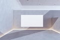 Modern concrete exhibition hall interior with blank white mock up banner, sunlight and shadows. Museum and art concept.