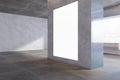 Modern concrete exhibition hall interior with blank white mock up frame on wall and window with city view. Royalty Free Stock Photo