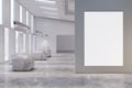 Modern concrete exhibition hall interior with empty white mock up poster, sunlight, showcases and numerous windows with city view Royalty Free Stock Photo