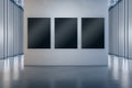 Modern concrete gallery interior with empty black mock up frames on wall. Museum room concept. Royalty Free Stock Photo