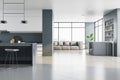 Modern concrete kitchen interior with panoramic city view, furniture and reflections on floor. Luxury living concept.