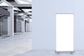 Modern concrete office corridor interior with empty mock up roll up banner on wall, glass doors with city view reflections. Royalty Free Stock Photo