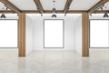Modern concrete and wooden empty interior with columns and white mock up frames on wall. Gallery and exhibition concept. 3D Royalty Free Stock Photo