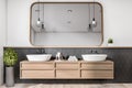 Modern concrete and wooden luxury bathroom interior with mirror, various objects. Hotel and luxury home concept.