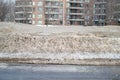 Modern condo buildings with huge windows and balconies and dirty snow Royalty Free Stock Photo