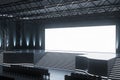 Modern conference hall with illuminated empty stage and seating. Event venue design. Royalty Free Stock Photo