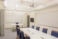 Modern conference / meeting room isolated. White office table and blue chairs. Business concept. Modern office style. Royalty Free Stock Photo