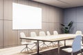 A modern conference room with empty chairs, a wooden table, and a large blank whiteboard on the wall, concept of a business Royalty Free Stock Photo