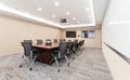 Modern conference room featuring a sleek flat-screen television mounted to the wall Royalty Free Stock Photo