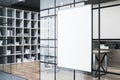 Modern conference room interior with white mock up poster on wall, glass partition, wooden flooring and bookcase. Royalty Free Stock Photo