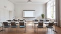 a modern conference room with white walls, a wooden floor and rows of chairs Royalty Free Stock Photo