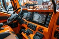 Modern construction vehicle dashboard showing advanced technology and ergonomic design features. Bright orange interior Royalty Free Stock Photo