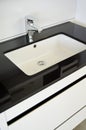 Modern and contemporary bathroom detail in a luxury home, black white sink and tap Royalty Free Stock Photo