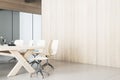 Modern contemporary meeting room interior with blank mock up place on wooden wall, table and chairs, decorative objetcs. 3D Royalty Free Stock Photo