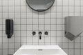 Modern contemporary public restroom minimal interior with metro style white tiles, round mirrors.
