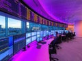 Modern control room with large screens, city view, and operators Royalty Free Stock Photo