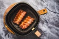 Modern cooking - preparing juicy spare ribs with honey sauce in airfryier, BBQ meat