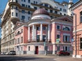 Modern corner apartment building with columns, built in the old style in 2000, Pogorelsky Lane, cityscape