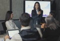 Modern Corporate Meeting. asian Businesswoman Giving Speech During Seminar With Coworkers In Office, Showing Growth Chart On Royalty Free Stock Photo