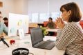 Modern corporate office open space with busy male and female staff employees using laptop computers sitting at work in Royalty Free Stock Photo