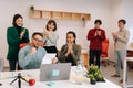 Modern corporate office open space with busy male and female staff employees using laptop computers sitting at work in Royalty Free Stock Photo