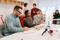 Modern corporate office open space with busy male and female staff employees using laptop computers sitting at work in Royalty Free Stock Photo