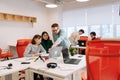 Modern corporate office open space with busy male and female staff employees using laptop computers sitting at work in Royalty Free Stock Photo