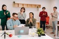 Modern corporate office open space with busy male and female staff employees using laptop computers sitting at work in Royalty Free Stock Photo